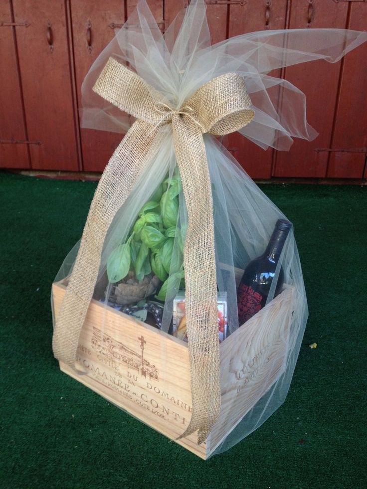 a wooden box filled with assorted items sitting on top of a grass covered ground