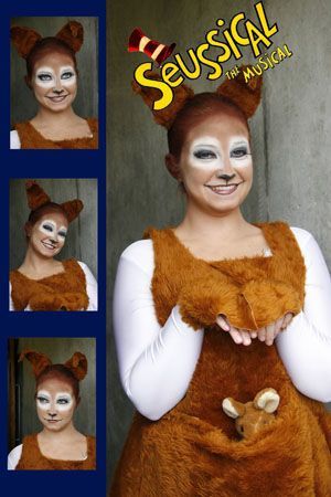 the woman is wearing a costume made to look like a bear