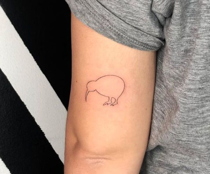 a person with a small pig tattoo on their arm