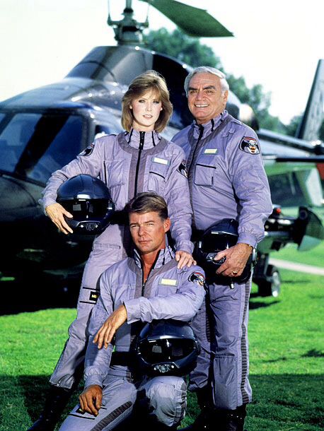 two men and a woman in uniform posing for a photo