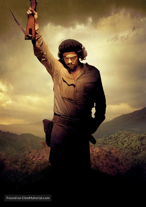 a man holding a knife in his right hand while standing on top of a hill