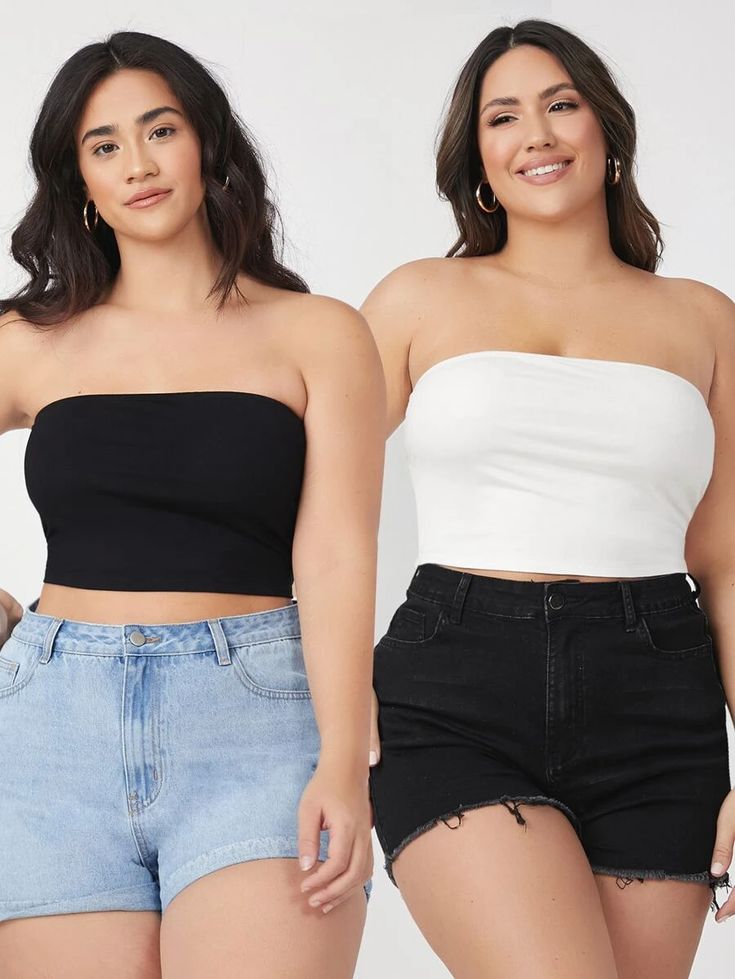 two women in black and white tops, one wearing high waisted denim shorts the other short