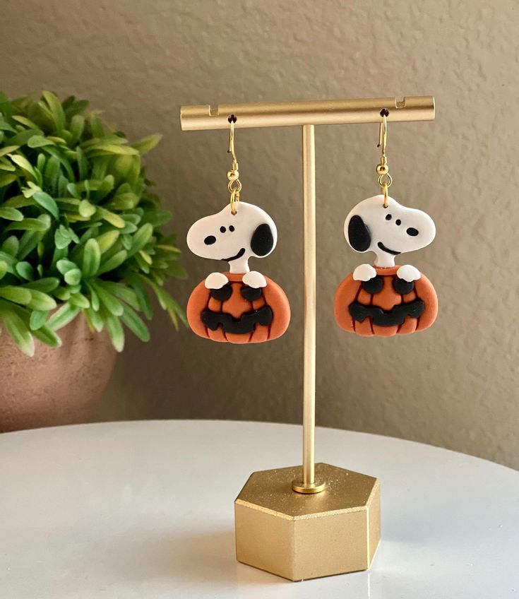 It's the Great Pumpkin!  This listing is for a pair of handmade, polymer clay earrings.  Snoopy measures 1.25 inches long.  -all hardware is nickel free. Snoopy Clay Earrings, Snoopy Clay, Halloween Earrings Diy, Dog And Pumpkin, Pumpkin Clay Earrings, Snoopy Pumpkin, Fimo Halloween, Pumpkin Clay, Clay Halloween