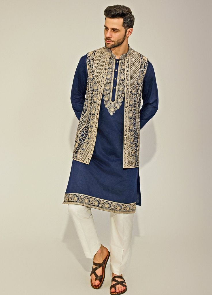 Embrace elegance with the Navy Blue Embroidery Silk Kurta Jacket Set, exquisitely crafted from a premium silk blend for a luxurious touch. The navy blue kurta features a timeless design, with classic embroidery along the collar and edges, offering a sophisticated and sleek silhouette. Paired with a beautifully beige embroidered jacket, adding a layer of refined charm. The deep navy hue contrasts strikingly with the intricate beige embroidery, creating a captivating visual appeal. Completed with Embroidered Straight Kurta In Indigo, Indigo Embroidered Straight Kurta, Embroidered Indigo Straight Kurta, Traditional Indigo Embroidered Kurta, Traditional Embroidered Indigo Kurta, Festive Indigo Embroidered Kurta, Festive Embroidered Indigo Kurta, Indigo Traditional Wear With Zari Work Long Sleeve, Straight Kurta Nehru Jacket With Intricate Embroidery For Reception