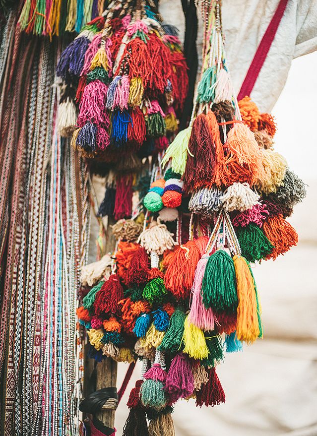 a person holding a bunch of colorful tassels