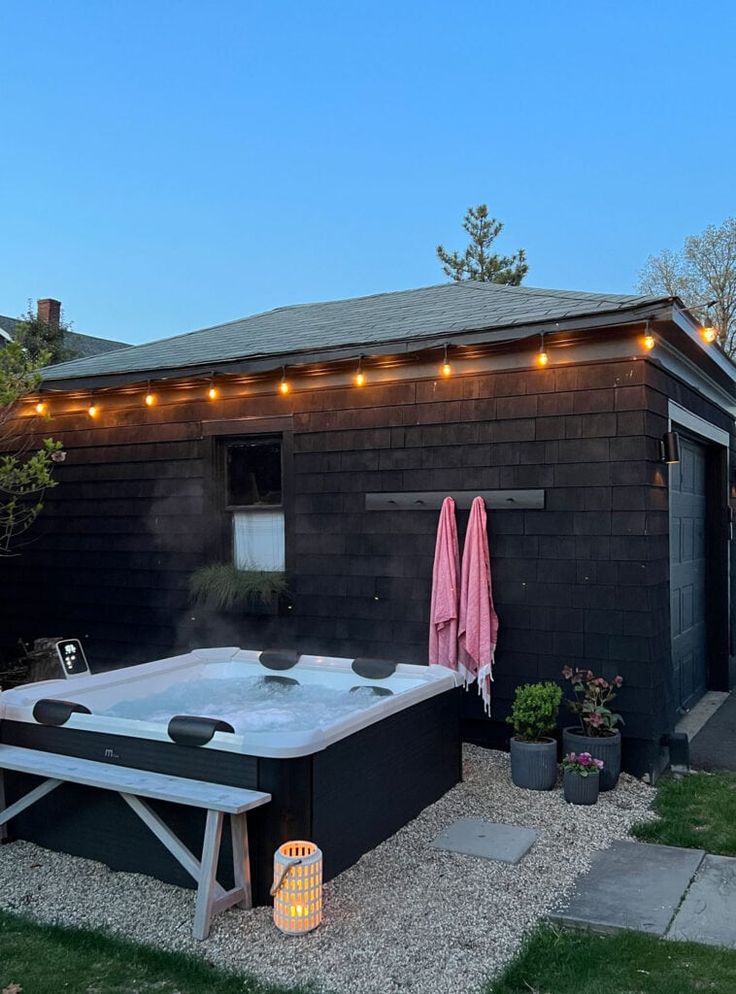 an outdoor hot tub with lights on the roof