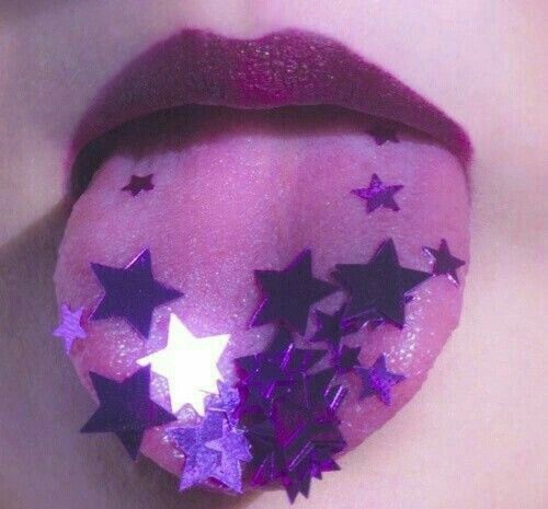 a woman's lips with stars painted on them