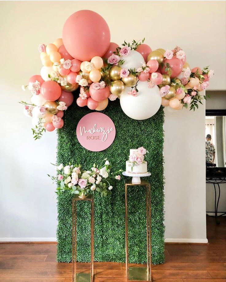 an instagram photo with balloons and greenery on the wall in front of it