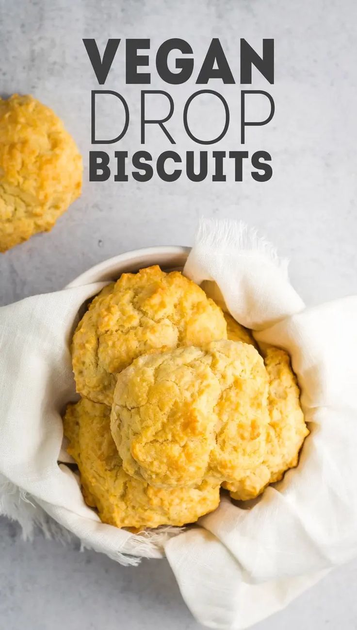 vegan drop biscuits in a white paper bag on a gray background with the words, vegan drop biscuits