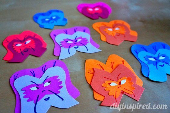 colorful paper cut outs with faces on them