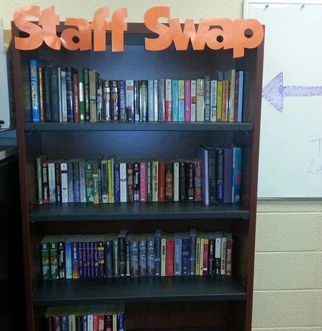 there is a book shelf with many books on it and a sign that says staff swap