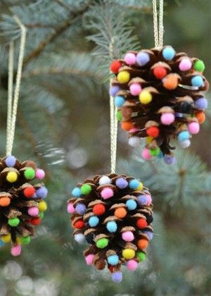 two pine cones with colored balls hanging from them