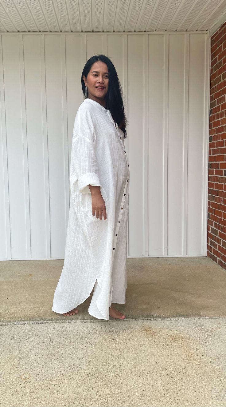 Relax in style with the white Aura shirtdress, a unique take on traditional loungewear. Made from breathable double gauze cotton, it's perfect for casual wear out, at home, or even as a beach coverup. The button-down design adds a touch of style and versatility to your wardrobe, ensuring comfort and convenience as you go about your day. White Cotton Tunic For Beach Cover-up, White Button-up Shirt Dress For Vacation, White Buttoned Shirt Dress For Beach, White Buttoned Shirt Dress For The Beach, White Long Shirt Dress For Beach, White Summer Shirt Dress With Buttons, White Bohemian Shirt Dress For Summer, Oversized White Cotton Shirt Dress, White Spring Tunic For Loungewear