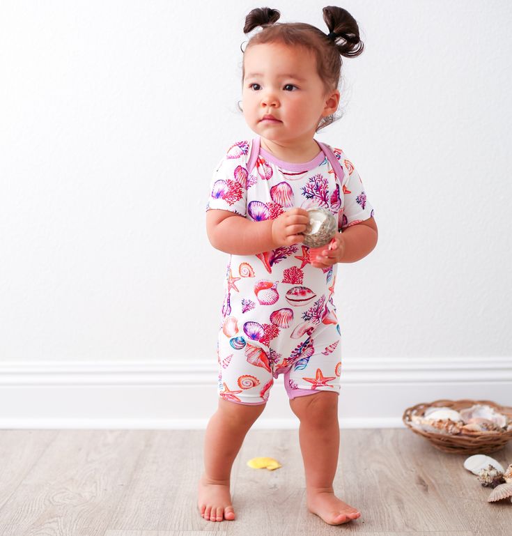 Our amazingly soft shortalls are the perfect one piece outfit to keep your babe feeling cool and comfy. These soft as butter shortalls are perfect for spring and summertime lounging. Lap shoulder design and snaps on legs makes for easy breezy changing. Made with super soft bamboo. 93% bamboo and 7% spandex Wash cold with like colors; stays soft wash after wash Playful Short Sleeve Onesie, Playful Short Sleeve Bubble Romper For Playdate, Cute Short Sleeve Bubble Romper For Playdate, Cute Bubble Romper With Short Sleeves For Loungewear, Cute Short Sleeve Bubble Romper For Loungewear, Fun Short Sleeve Onesie For Playtime, Cute Short Sleeve Jumpsuits And Rompers For Playtime, Short Sleeve Onesie For Summer Loungewear, Playful Short Sleeve Bodysuit For Playwear