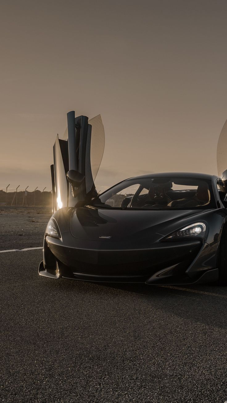 a black sports car with its doors open