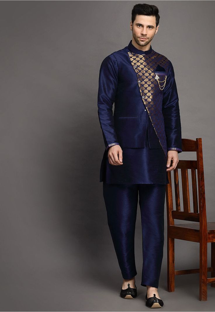 Art Silk Kurta in Navy Blue This Readymade attire is Enhanced with Buttons. Crafted in Chinese Collar Neck and Full Sleeve Available with an Art Silk Pajama in Navy Blue and an Art Brocade Silk Nehru Jacket in Navy Blue Do note: Brooch and Footwear shown in the image is for presentation purposes only. Half to one inch may vary in measurement. (Slight variation in actual color vs. image is possible) Blue Bandhgala With Zari Work For Navratri, Blue Bandhgala For Navratri Designer Wear, Royal Blue Sherwani For Eid, Festive Blue Bandhgala With Cutdana Details, Festive Blue Nehru Jacket With Cutdana, Royal Blue Long Sleeve Sherwani, Blue Embroidered Nehru Jacket With Traditional Drape, Embroidered Blue Nehru Jacket With Traditional Drape, Royal Blue Sherwani For Festive Occasions