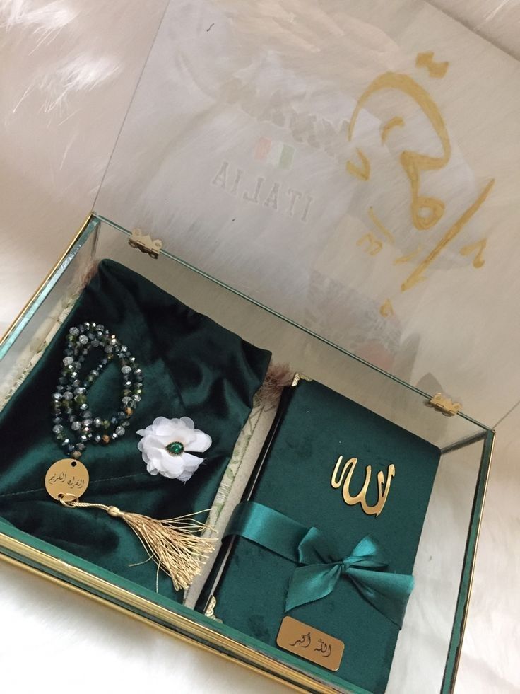 an open gift box with jewelry inside it