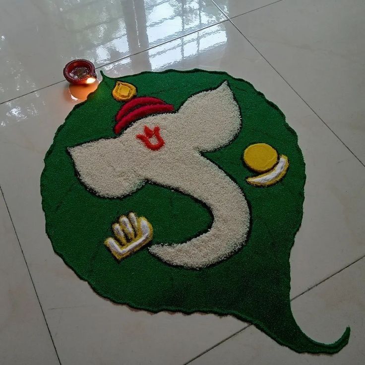 a green and white rug with an elephant on it