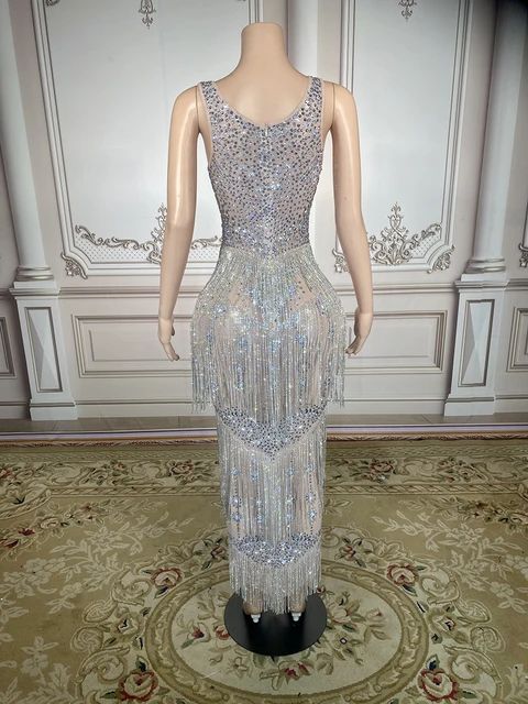 This Maxi Rhinestones Stones Dress is a stunning piece of clothing. It is made with Women`s crystals and Rhinestone, and is plated with Silver Plated, Plated, and Alloy. It is perfect for any special occasion, such as an anniversary or a party. This dress is truly innovative, with its unique design and intricate details. It is sure to make you stand out in any crowd. Plus, it is made to order, so you can be sure that it will fit you perfectly. Please note that this is a made to order item and wi Luxury Embellished Evening Dress For Glamorous Events, Glamorous Rhinestone Evening Dress For Party Season, Glamorous Evening Dress With Rhinestones For Party Season, Glamorous Rhinestone Fringe Prom Evening Dress, Elegant Rhinestone Dress For Glamorous Events, Sleeveless Dresses With Rhinestone Fringe For Wedding, Glamorous Evening Dress With Rhinestones, Glamorous Rhinestone Evening Dress For Glamorous Events, Champagne Evening Dress With Rhinestones For Party