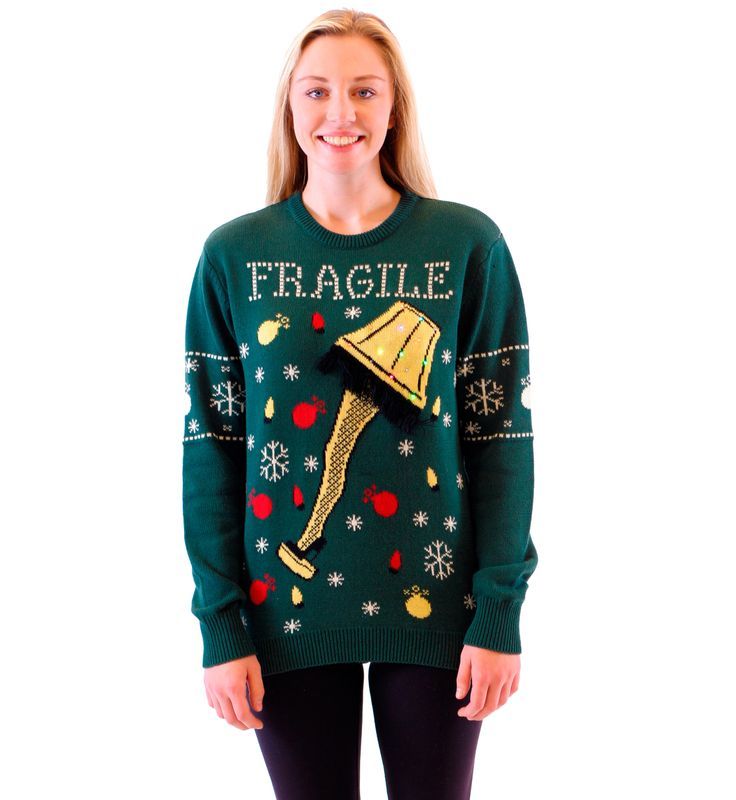 a woman wearing an ugly christmas sweater with a bell on it