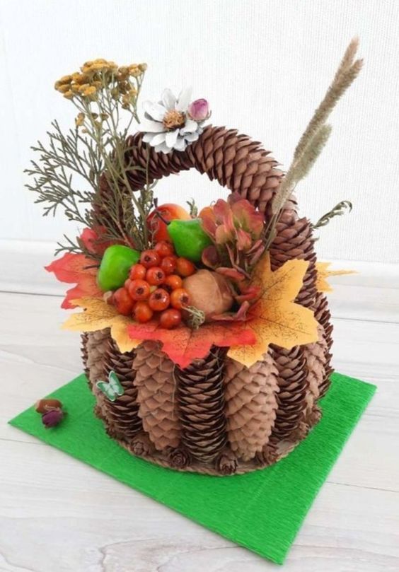 a basket filled with pine cones and flowers