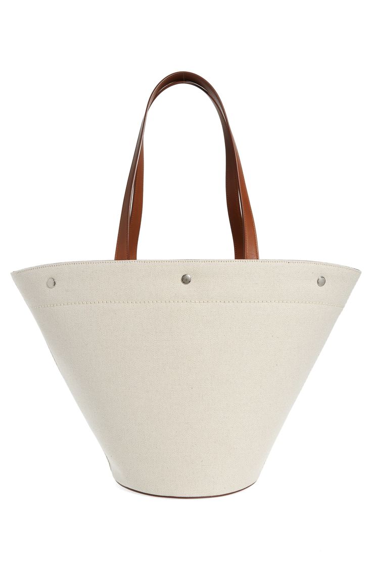 Unbleached canvas made of cotton and linen furthers the casual, go-everywhere appeal of this shapely tote fronted by bold logo lettering. Open top Top carry handles; removable, adjustable crossbody strap Structured silhouette with flat base for stability Textile with leather trim Made in Italy Designer Handbags Cream Canvas Bucket Bag, Canvas Bucket Bag With Leather Trim For Shopping, White Cotton Shoulder Bag With Leather Handles, Everyday Canvas Bucket Bag, Modern Canvas Bucket Bag With Double Handle, Bucket Canvas Bag With Leather Trim, Canvas Bucket Bag With Tote Shape, Cotton Bucket Bag With Canvas Lining, Canvas Bucket Bag Tote With Canvas Lining