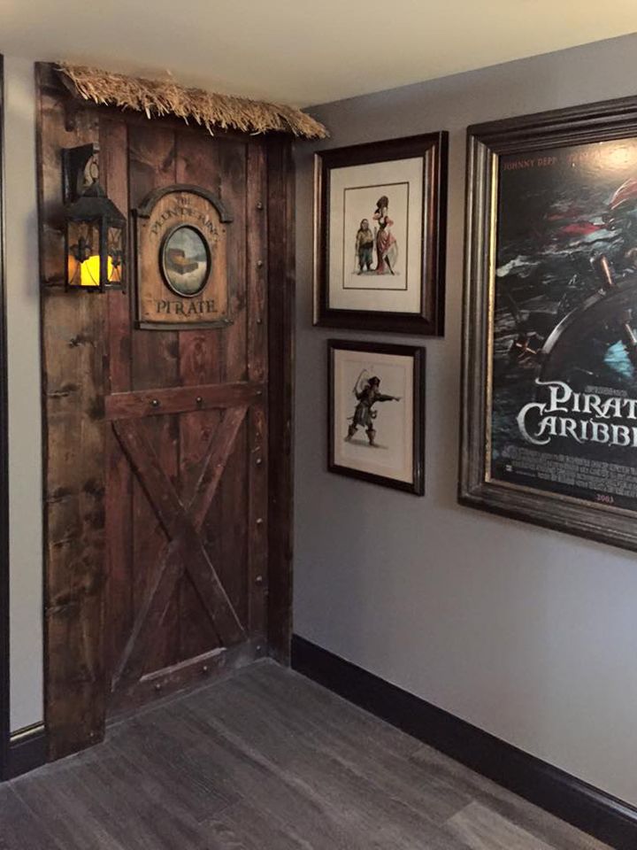 an entry way with pictures on the wall and framed movie posters hanging on the wall