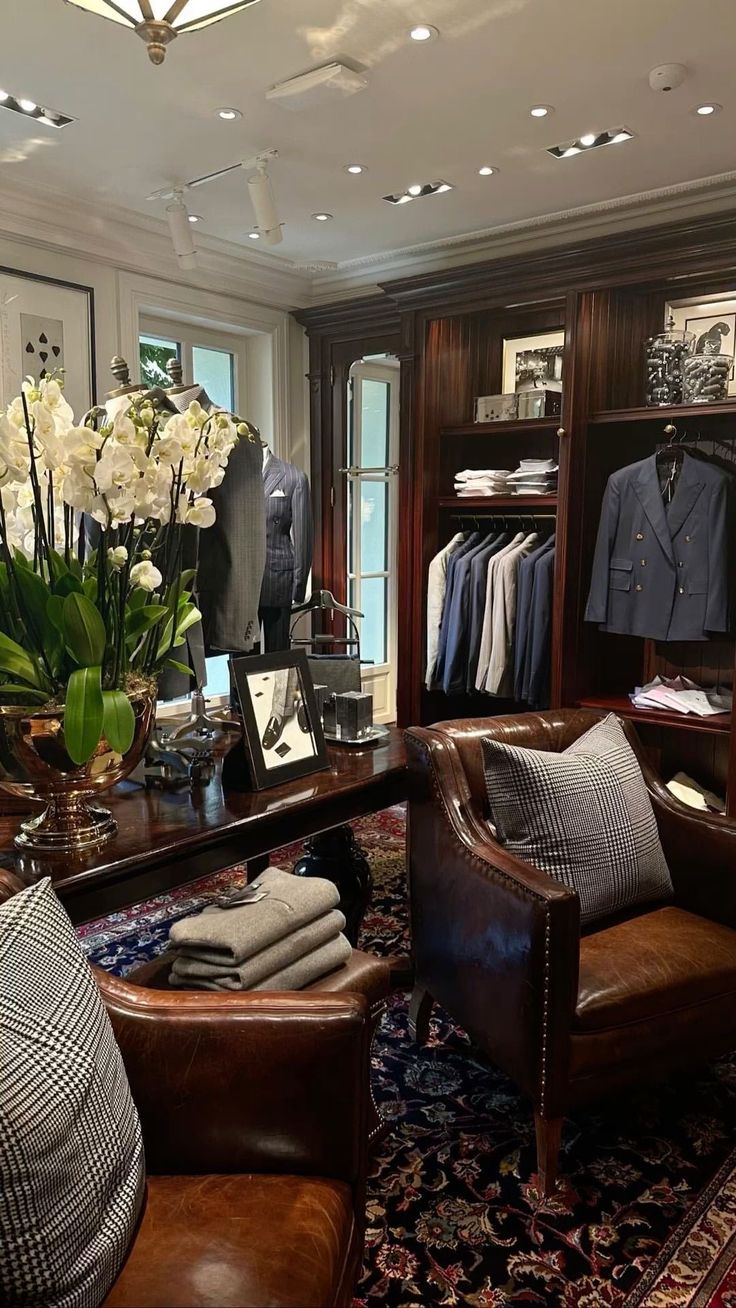 a living room filled with furniture and lots of clothes on shelves next to a window