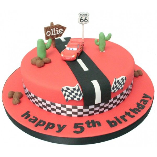 a red birthday cake with cars on it and a sign that says ollie happy 5th birthday