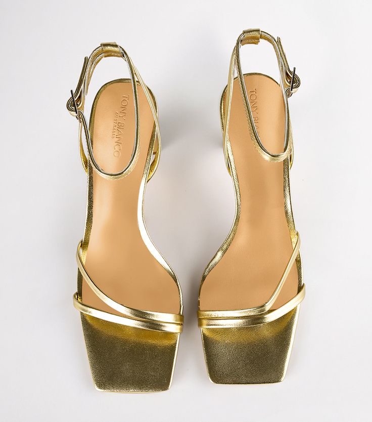 Complete your party look with our Corso strappy heels in gold nappa. Designed with slender foot-framing straps, an adjustable and secure ankle strap, and is finished with a mid-height stiletto heel. -Material: Leather Upper & Lining -Sole: Rubber -Fit: True to size -Toe-shape: Squared toe-shape -Heel: 8.5cm stiletto heel Shop Heels, Thigh High Boots Flat, Embellished Heels, Heels Online, Metallic Shoes, Bridal Heels, Tony Bianco, Metallic Heels, Bow Heels