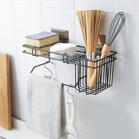 a kitchen shelf with utensils and other items hanging on it's side