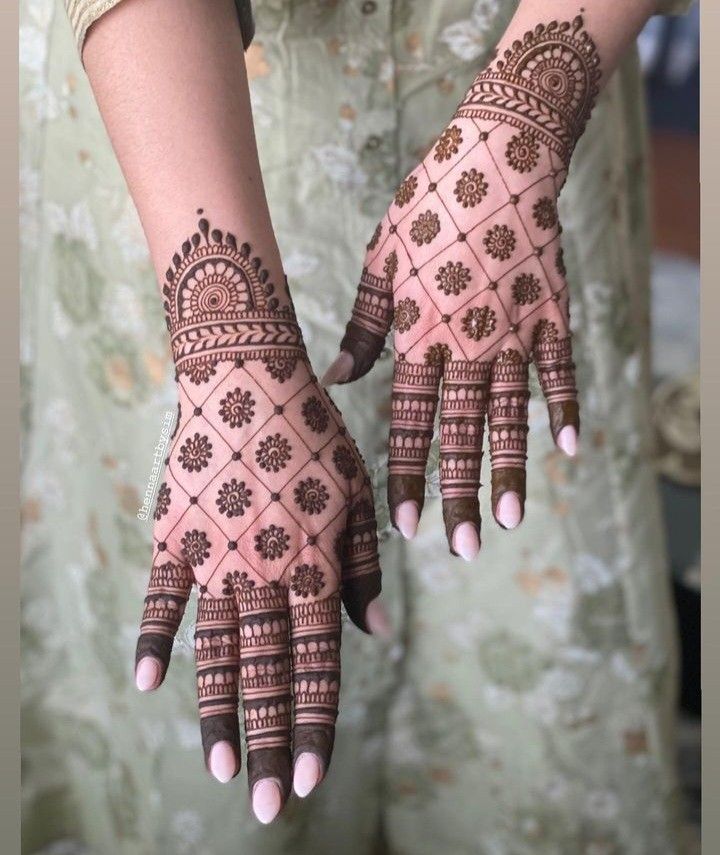 two hands with henna designs on them