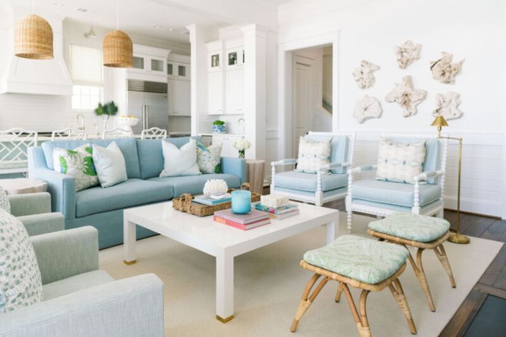 a living room filled with blue couches and chairs