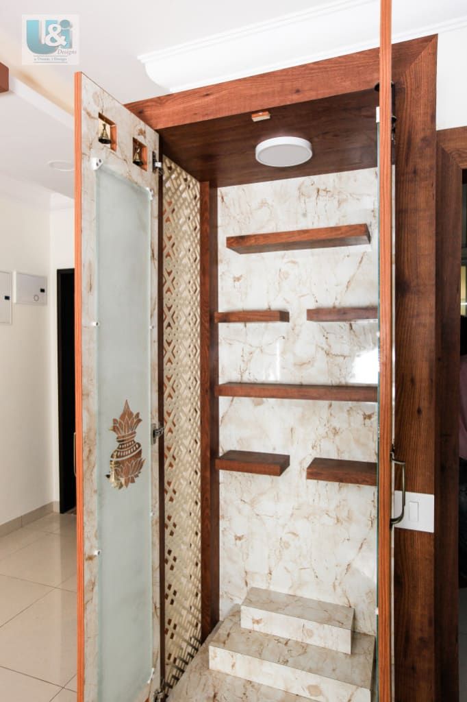 a bathroom with marble walls and shelves in the shower area, next to a tiled floor