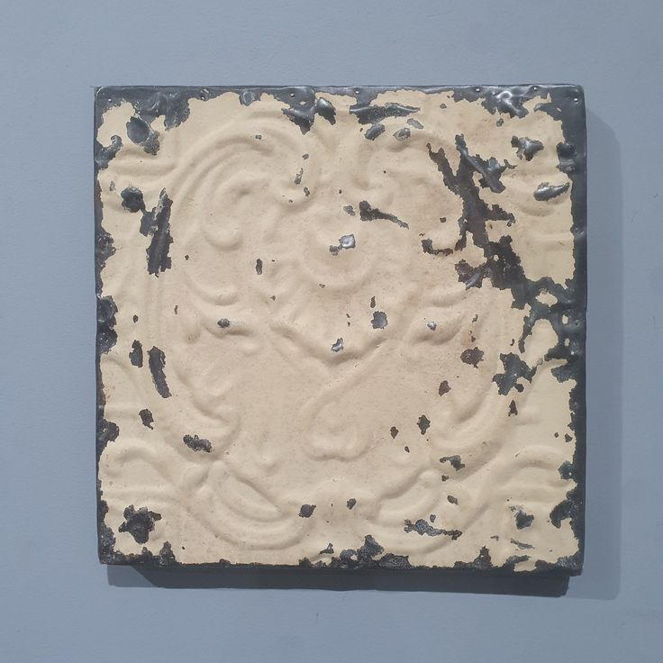 a piece of art that looks like it has been made out of clay and paint