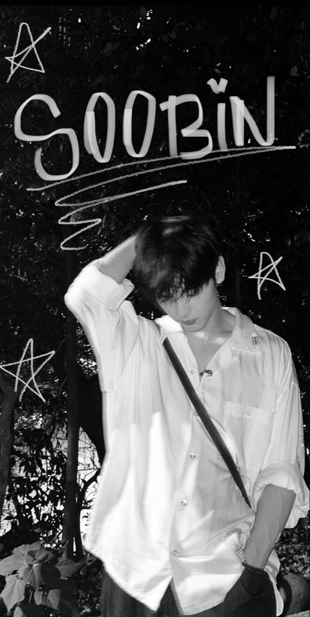 black and white photograph of a young man leaning against a wall with the word soobin written on it