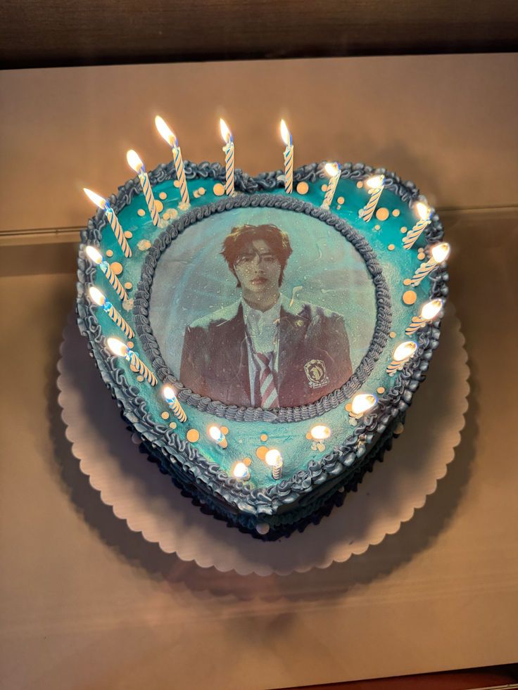 a birthday cake with candles and a photo on it