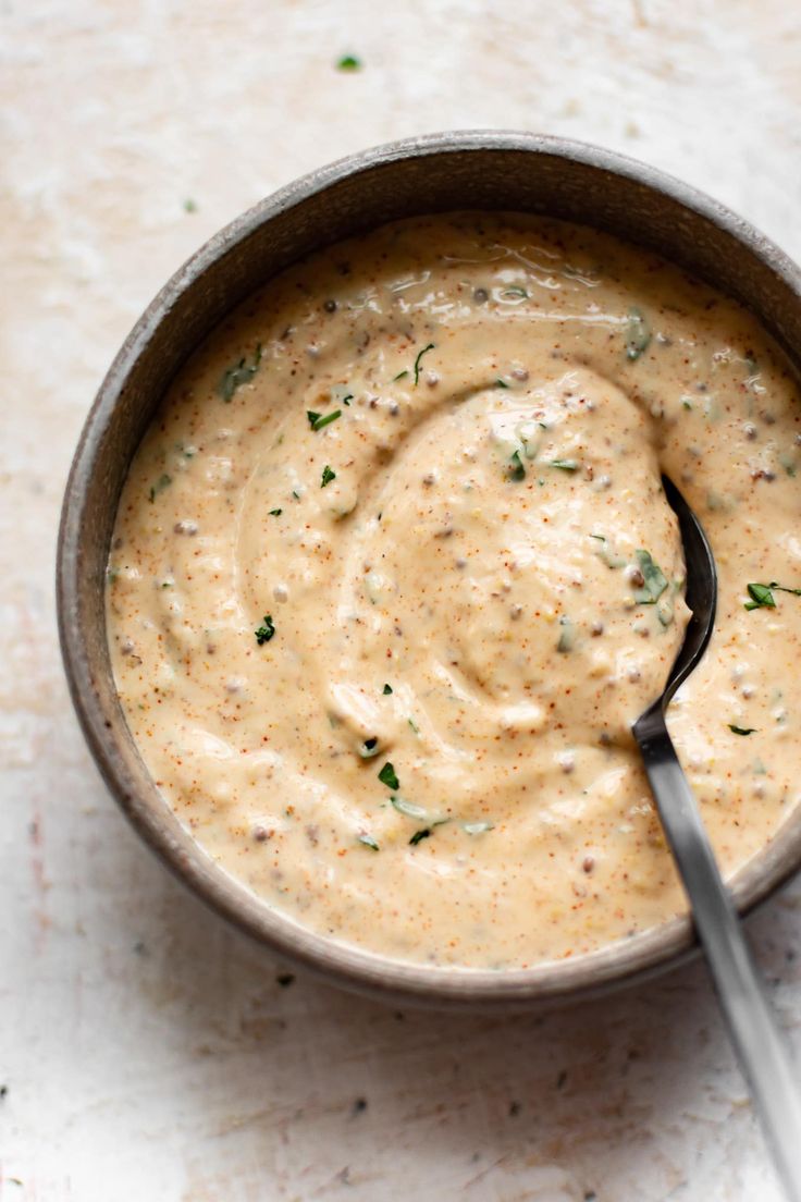 a small bowl filled with sauce on top of a table