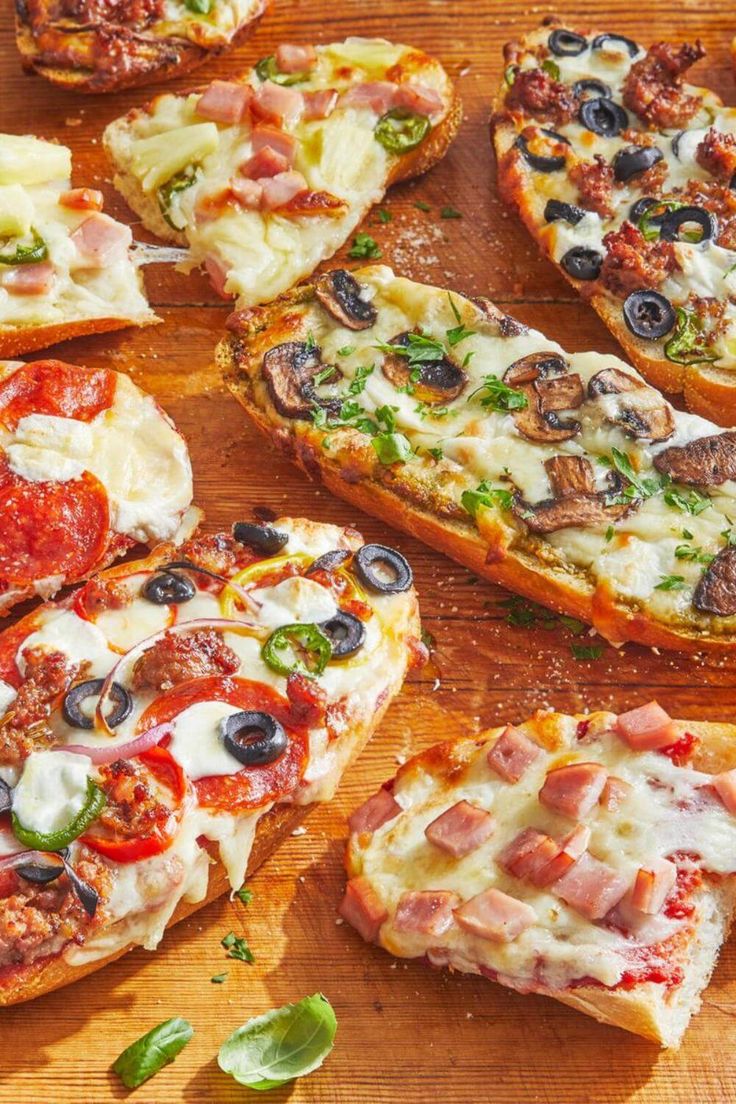 several slices of pizza with various toppings on a cutting board