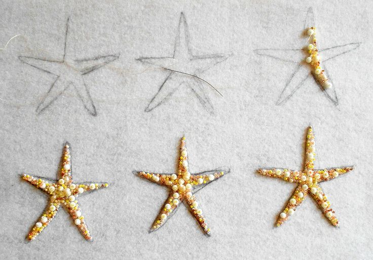 four starfishs are shown in three different sizes and colors on a white surface