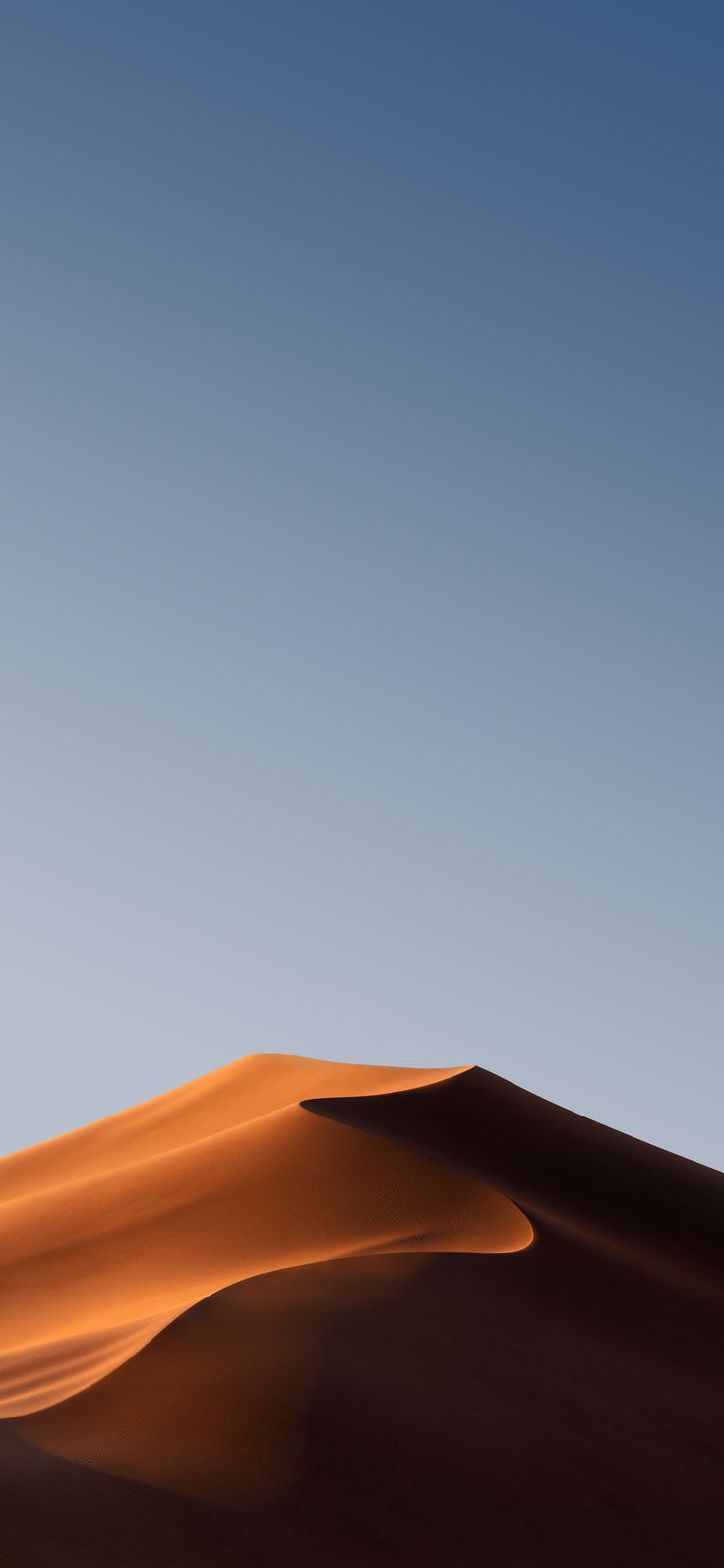 an image of a desert landscape with sand dunes and blue sky in the background at dusk