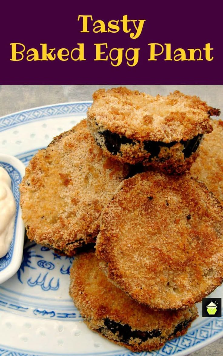 some fried food on a blue and white plate next to a bowl of yogurt