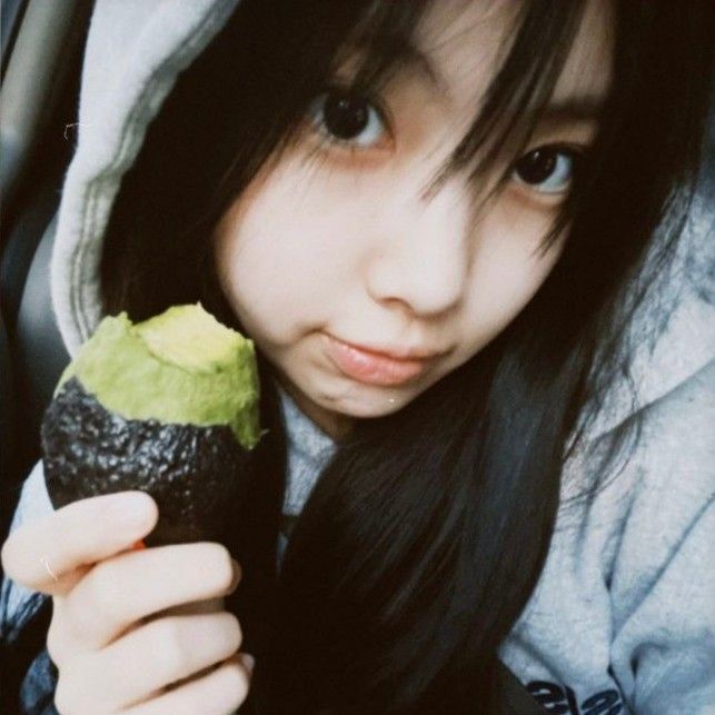 a young woman holding an ice cream cone in her hand