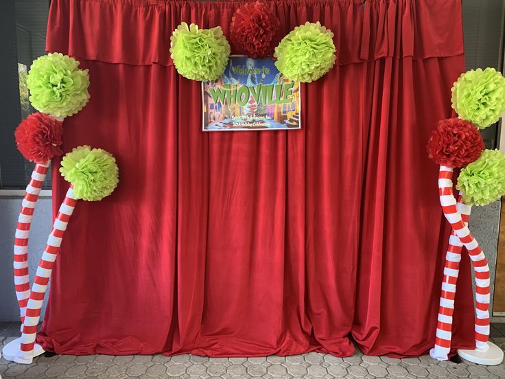 red drapes with green pom poms and candy canes on the sides