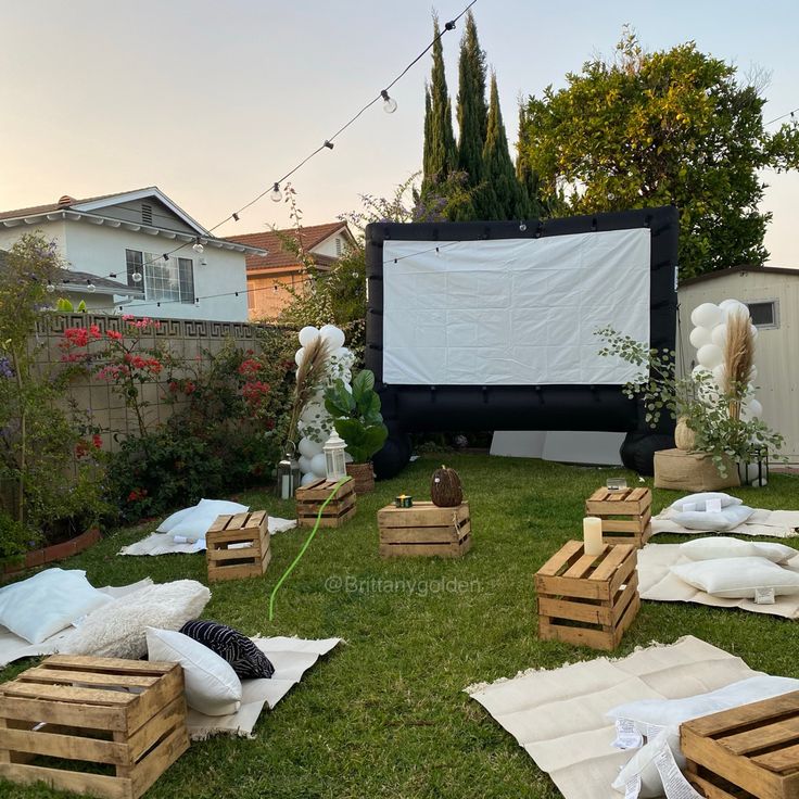 an outdoor movie is set up in the backyard