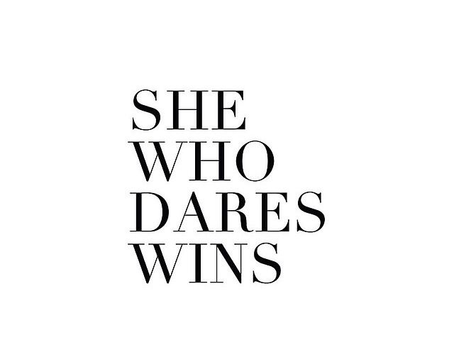 the words she who dares wins are in black and white letters on a white background