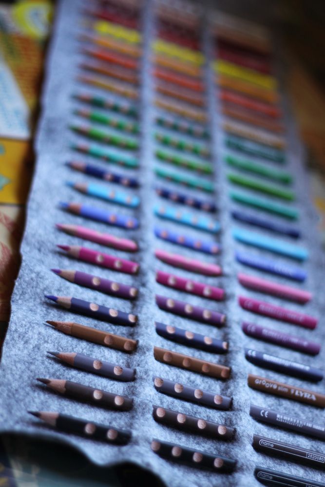 there are many different colored crayons lined up on the trays in this photo