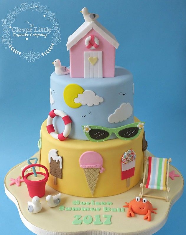 a birthday cake with an ice cream shop and beach scene on it's side