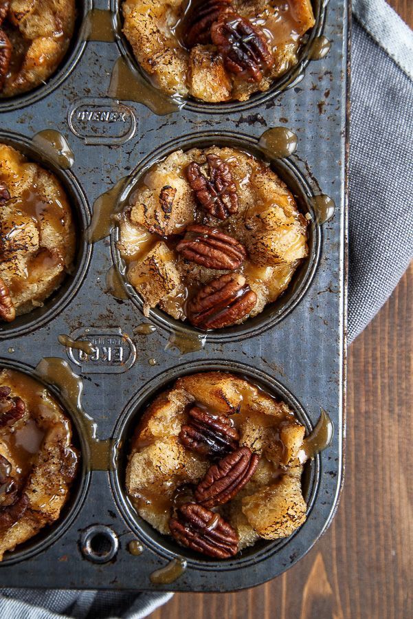 a muffin tin filled with cupcakes covered in pecans