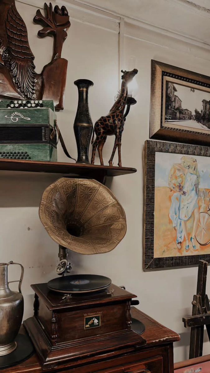 an antique record player and other antiques are on display in the corner of a room